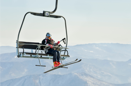 Lone Skiier Riding Ski Lift