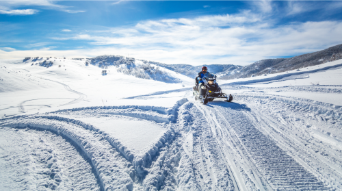 Person Snowmobiling in Big Sky Montana