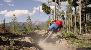 BSR Mtn Bike Person Riding A Mountain Bike Down a Trail in Big Sky Montana