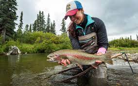 Person Holding A Fish in River