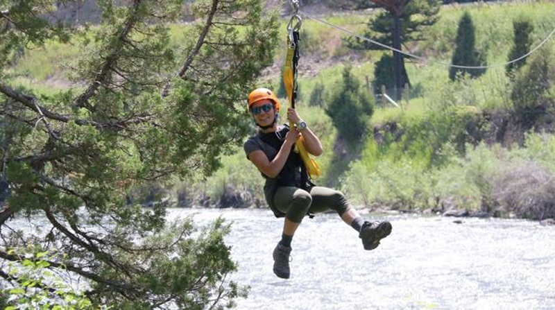 Man Zip lining across river