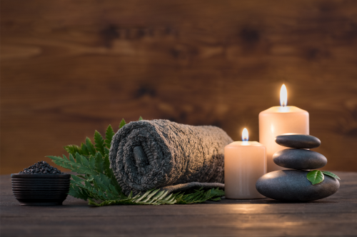Spa Rocks, Lit Candle, and Towel