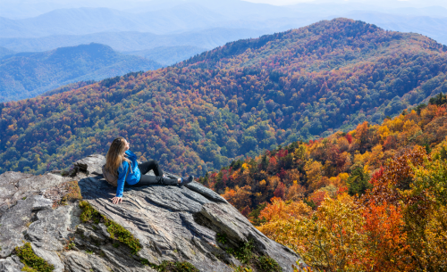 Woman Relaxing on Fall Hike at Top of Mountain