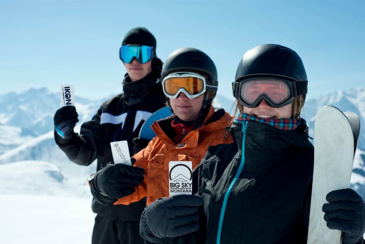 Three People Holding Ski Cards/Passes